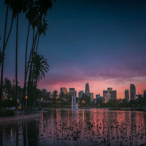 Illuminated buildings against sky at night
