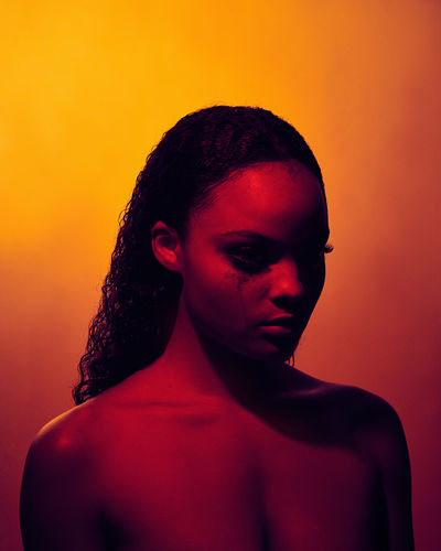 Young woman against orange background