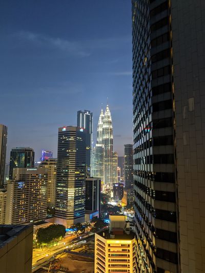 Modern buildings in city against sky