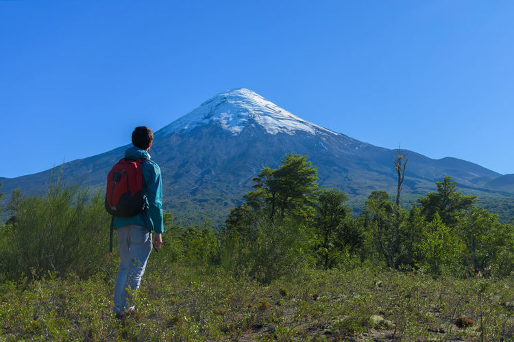 Rear view of man standing against sky