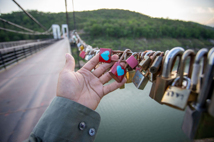 Close-up of padlocks on bridge