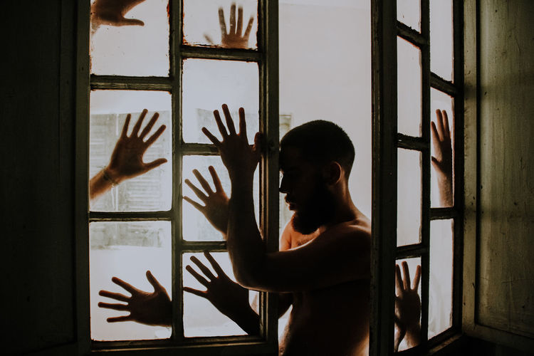 WOMAN STANDING BY WINDOW