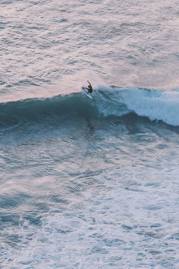 High angle view of man surfing on sea