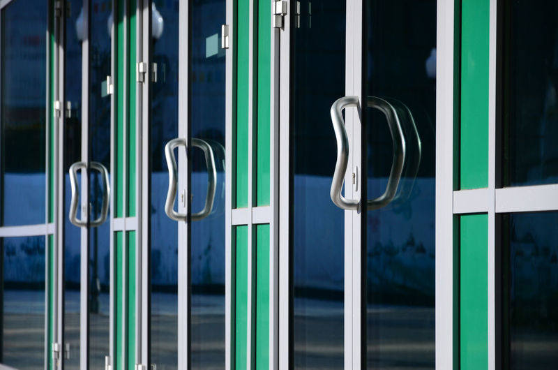 Close-up of metal handles hanging from door
