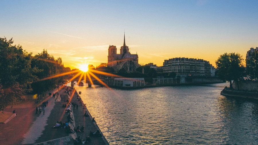 River passing through city buildings at sunset