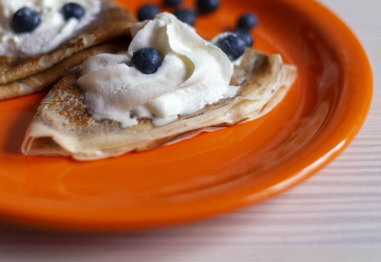 Delicious homemade pancakes with fruits and blur background on the table