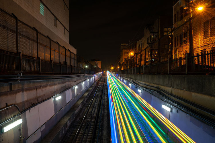 Colorful light trails from a holiday train coming out from an underground tunnel at night in chicago