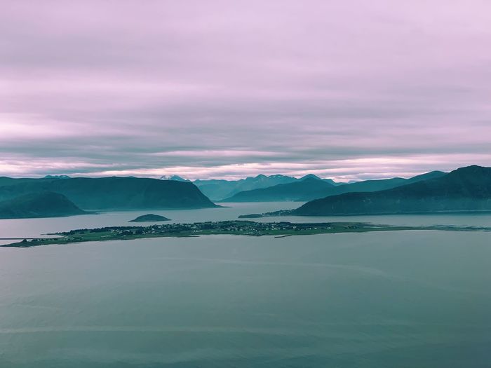 Aerial view of the norwegian coast, fjords and mountain ranges, cloudy weather, evening light 