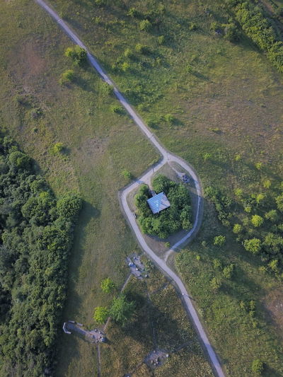 High angle view of road amidst field in forest