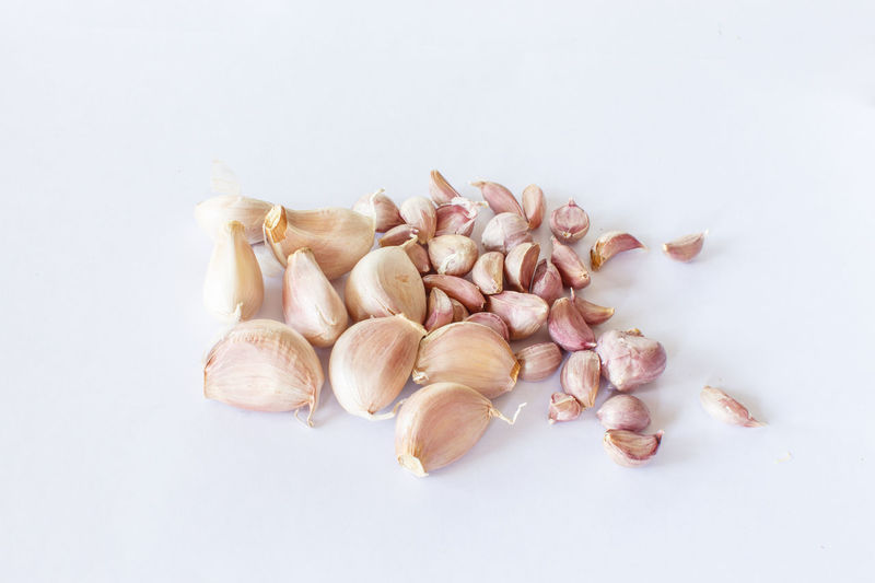 Close-up of garlic on white background