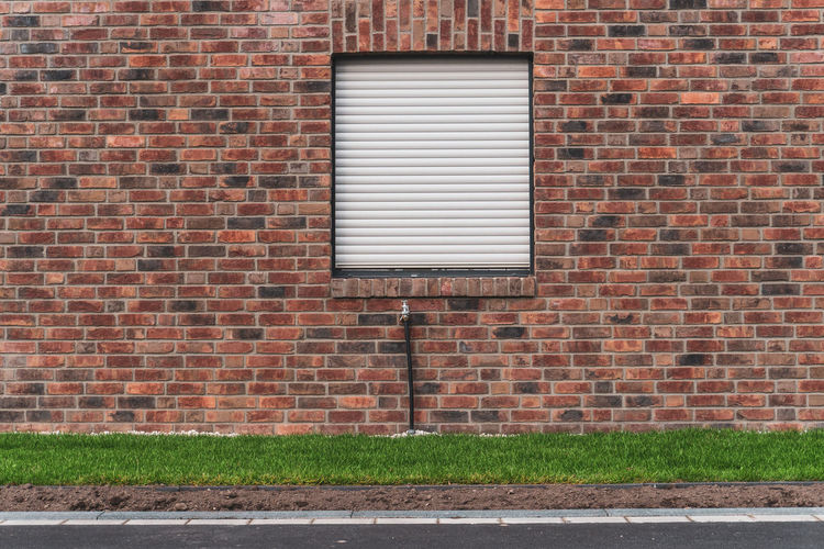 View of brick wall by building