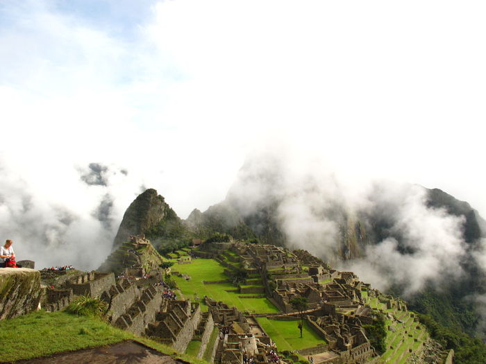 Magnificient view of machu picchu with some clouds above in a sunny day