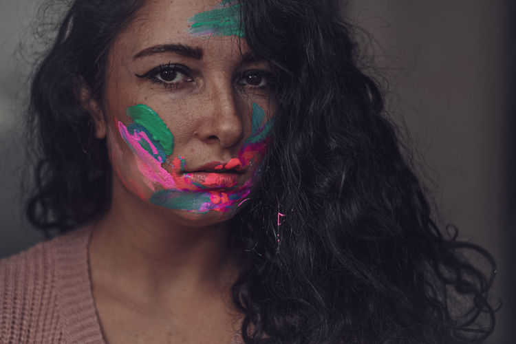 Portrait of beautiful woman with multi colored face