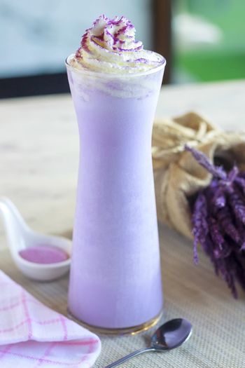 Close-up of purple drink on table