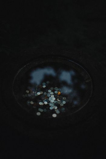 High angle view of coins in pond