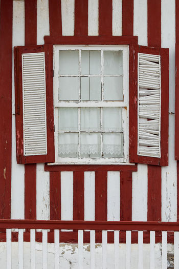 Typical red houses window in costa nova - aveiro against sky