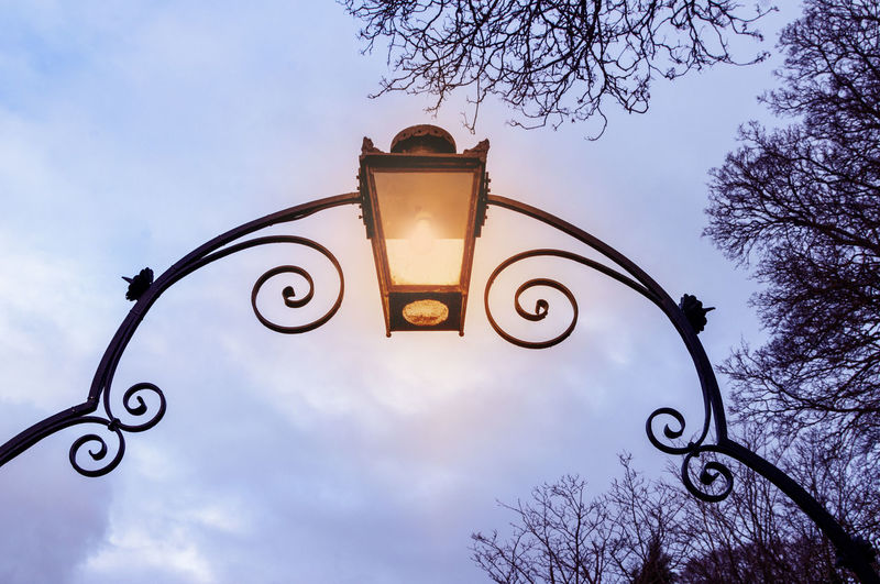 Archway entrance with shining lantern lamp. wrought iron arch. 