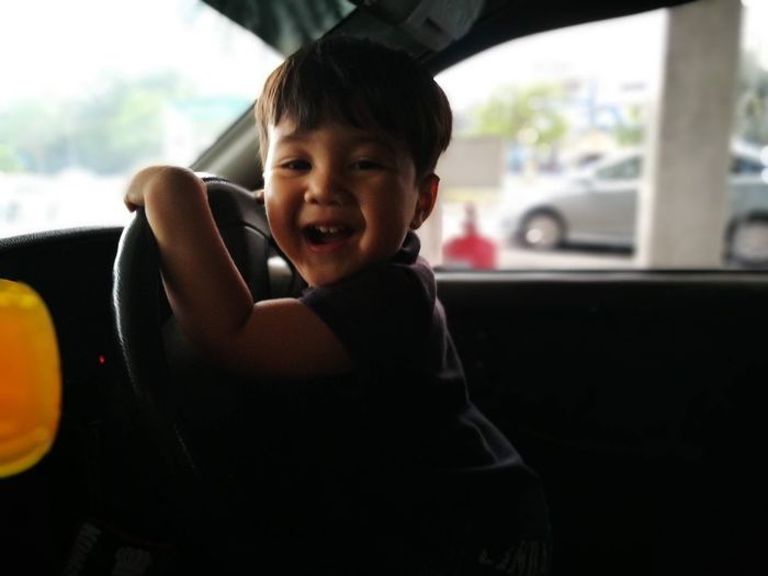 Portrait of boy sitting in car