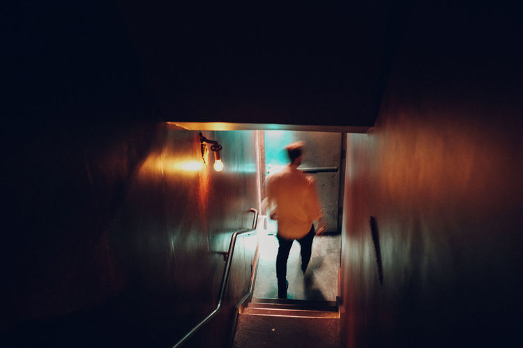 Man standing in illuminated room