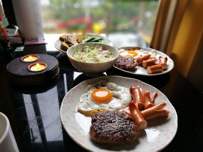Food in plates on table at home