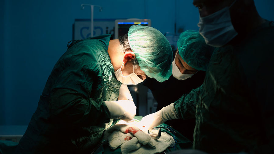 Medical team of surgeons in hospital doing minimal invasive surgical interventions. 