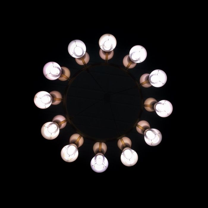 Directly below shot of illuminated light bulbs against black background