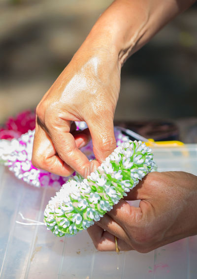 Close-up of woman making flower bouquet