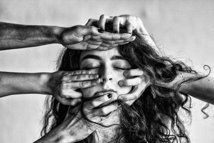 Cropped image of hands hitting woman