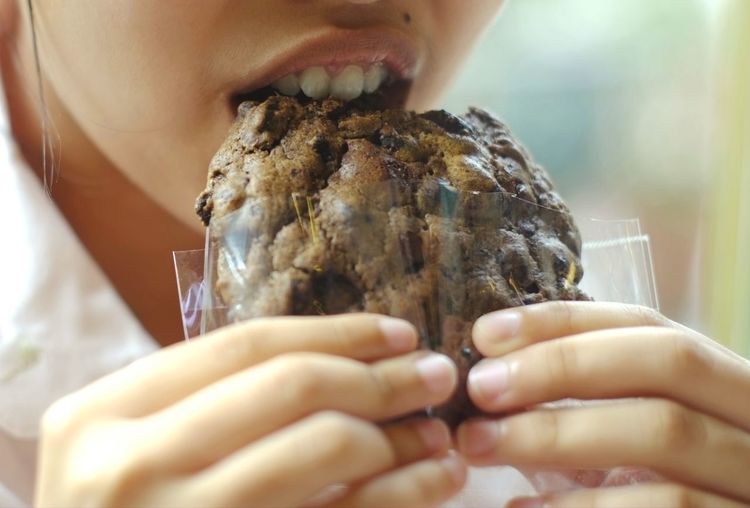 Close-up of girl eating cookie