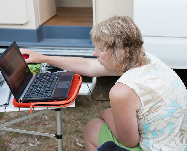 High angel view of mature woman using laptop outdoors