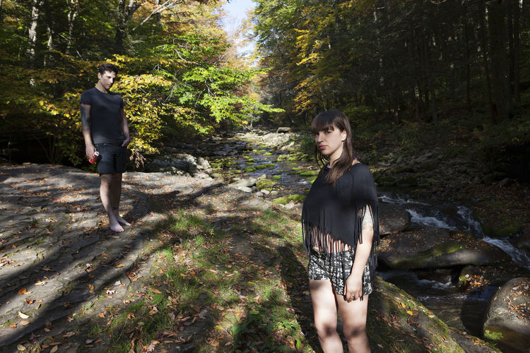 Young couple standing in a mossy stream