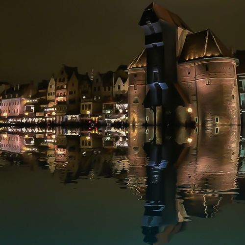 Reflection of illuminated buildings in water at night