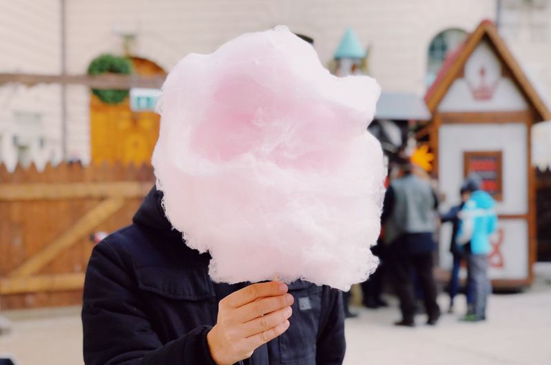 Close-up of person holding cotton candy