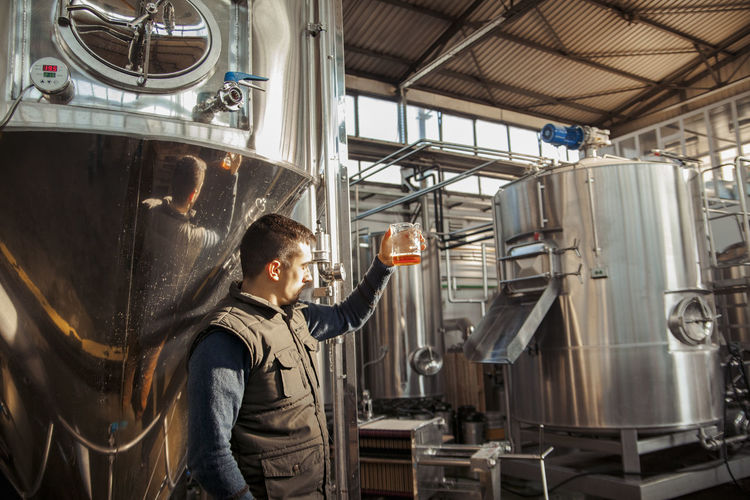 Young man working in craft brewery