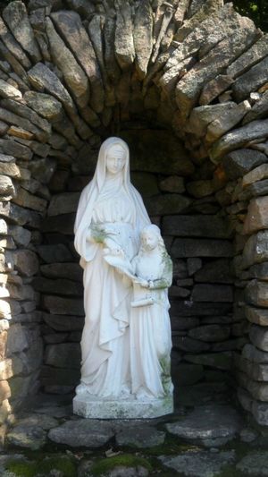 Statue against stone wall