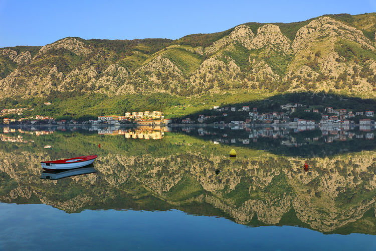 Reflection of rijeka crnojevica and mountains on lake skadar