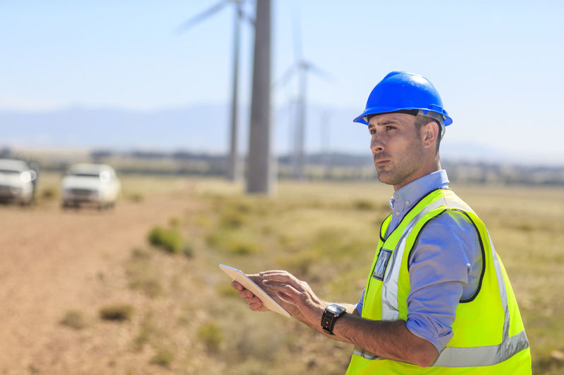 Engineer using tablet on a wind farm