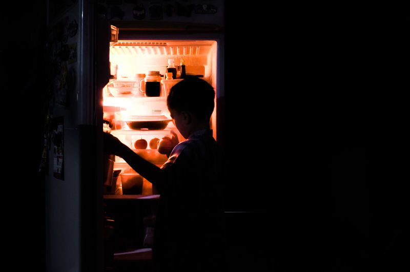 Boy opening refrigerator