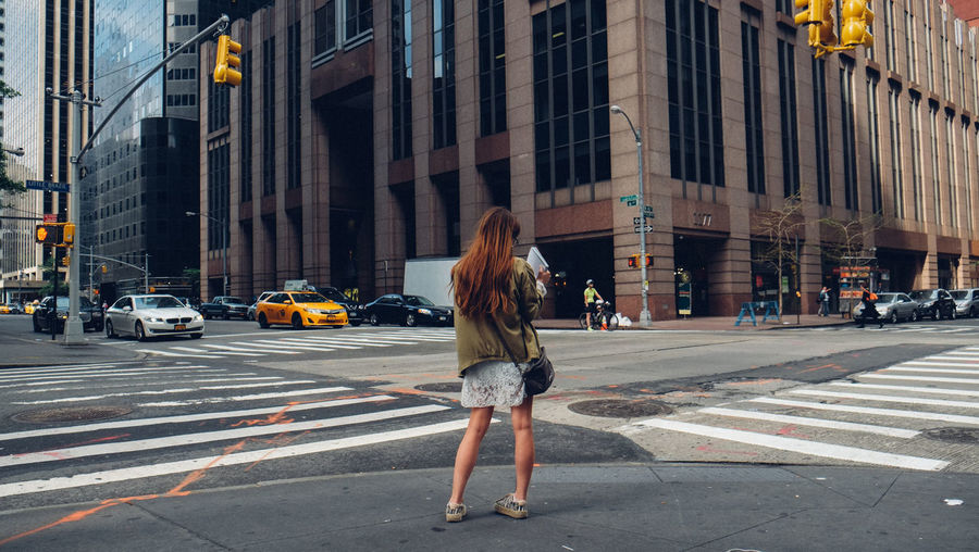 Woman standing on city street