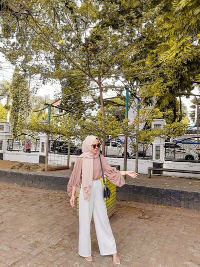 Full length of woman wearing hijab standing at park