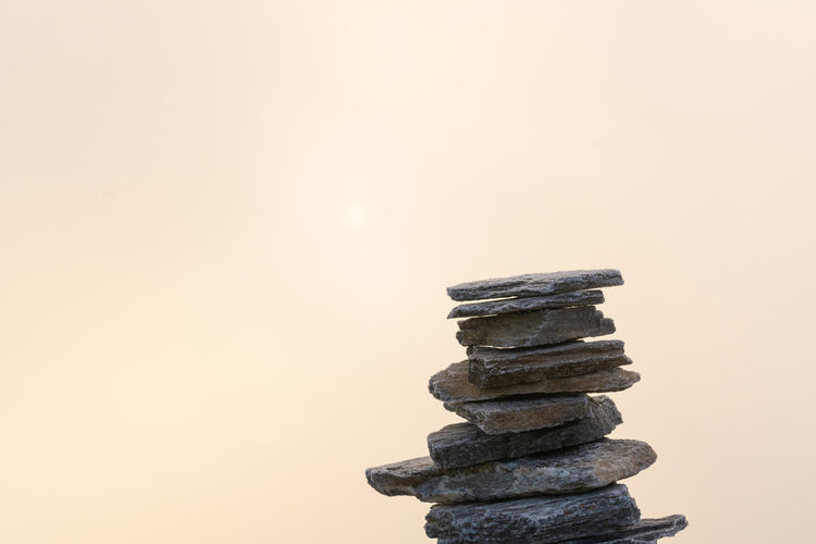 Stack of stones against clear sky during sunset