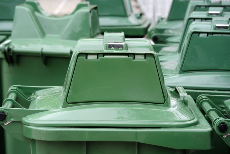 Close-up of green garbage bins