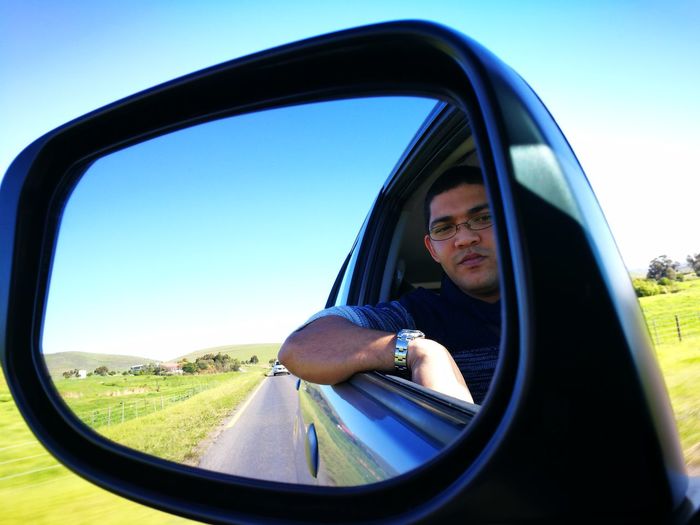 View of man in side-view mirror