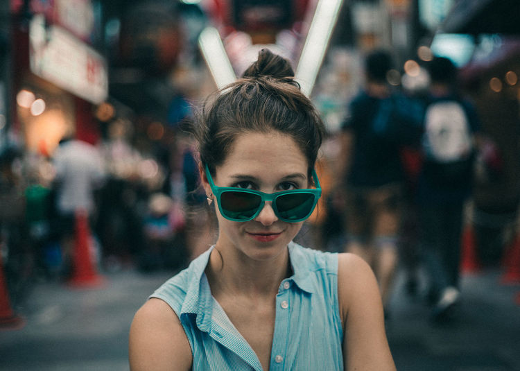 Close-up portrait of a young woman in sunglasses
