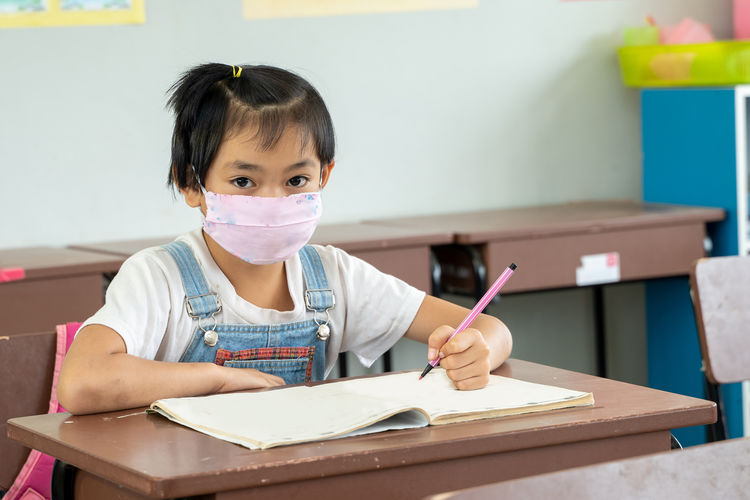 Kids wearing mask protect and safety from corona virus in classr