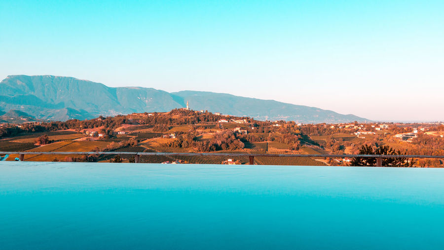 Artistic picture of infinity pool over prosecco hills.