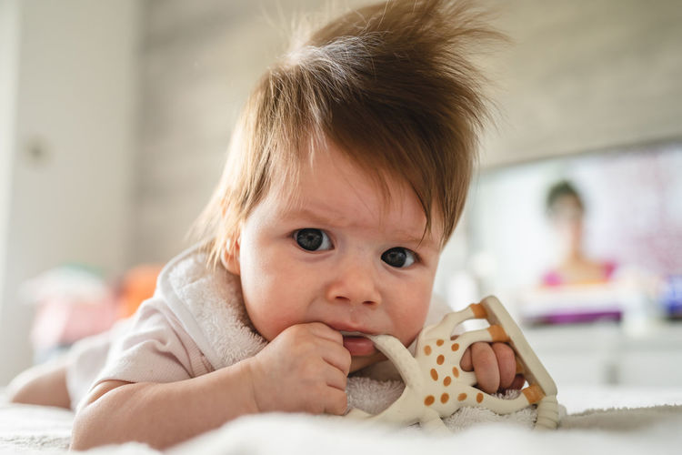 Close-up of cute girl eating food at home