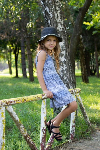 Portrait of smiling girl wearing hat at park