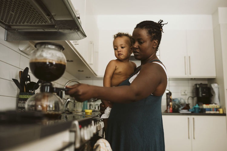 Mother with toddler in kitchen