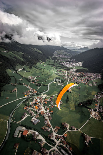 Aerial view of landscape against sky, paragliding.